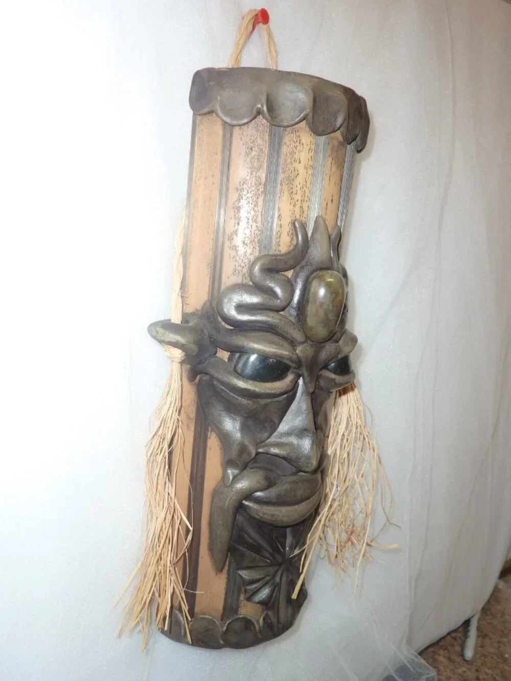Clay mask on wood. Size 12 x 4 1/2 x 2 1/2 inches by artist Krisna Brasil